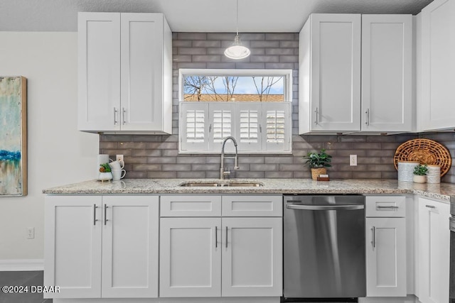 kitchen with dishwasher, white cabinets, backsplash, and a sink