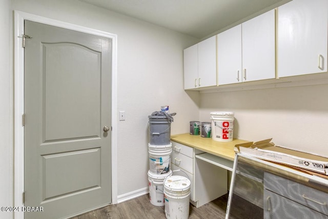 washroom with wood finished floors and baseboards