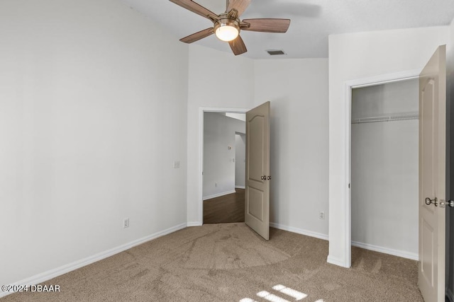 unfurnished bedroom with baseboards, visible vents, ceiling fan, a closet, and carpet flooring