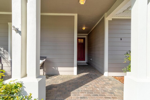 property entrance with a garage and covered porch