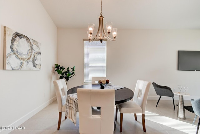 tiled dining room with a chandelier