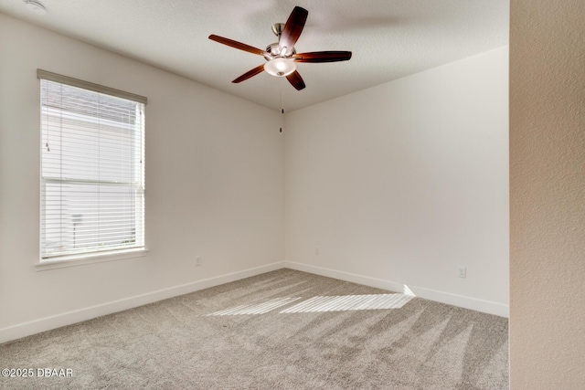 unfurnished room featuring a textured ceiling, carpet floors, and ceiling fan