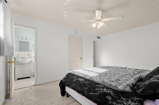 bedroom featuring sink, ceiling fan, and connected bathroom