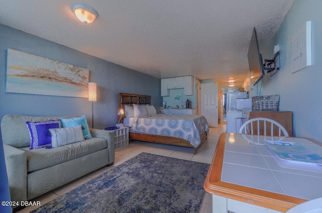 bedroom featuring a textured ceiling and light tile patterned floors