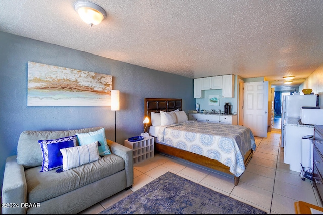 bedroom featuring a textured ceiling and light tile patterned floors