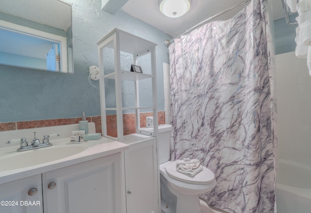 full bathroom with toilet, shower / tub combo, and vanity