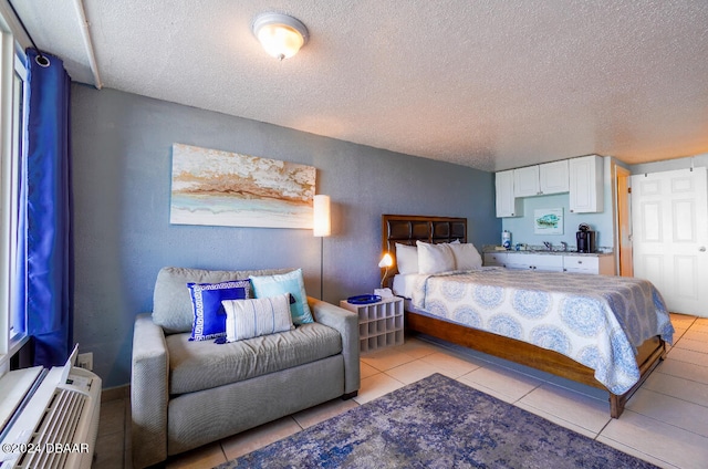 bedroom with a textured ceiling and light tile patterned floors