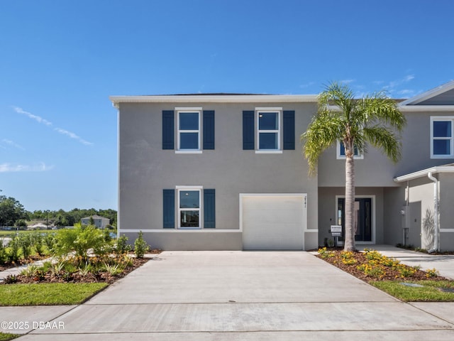 2724 Golden Trout Ln, Edgewater, FL 32141 - view of front of house featuring stucco siding, a garage, and driveway