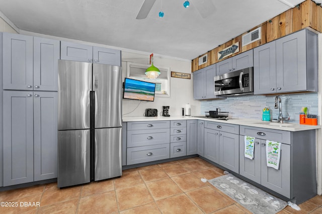 1167 Ocean Shore Blvd Unit 110, Ormond Beach, FL 32176 - kitchen featuring appliances with stainless steel finishes, gray cabinets, a sink, and ceiling fan