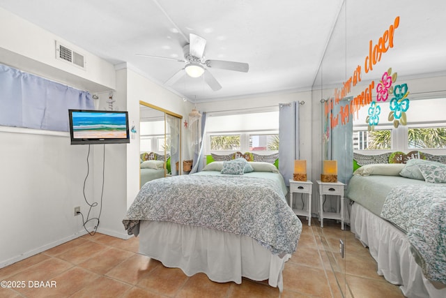 1167 Ocean Shore Blvd Unit 110, Ormond Beach, FL 32176 - bedroom featuring light tile patterned floors, a ceiling fan, a closet, and baseboards