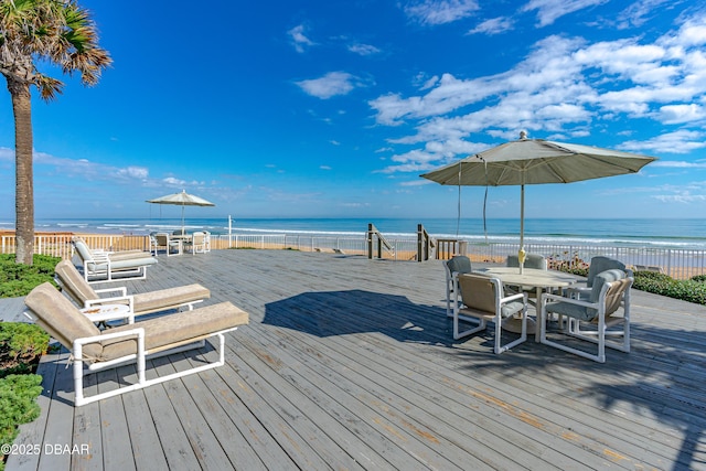 1167 Ocean Shore Blvd Unit 110, Ormond Beach, FL 32176 - wooden terrace featuring outdoor dining space and a water view
