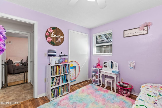 bedroom with ceiling fan and dark wood-type flooring