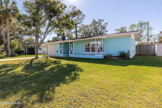 single story home featuring a front lawn