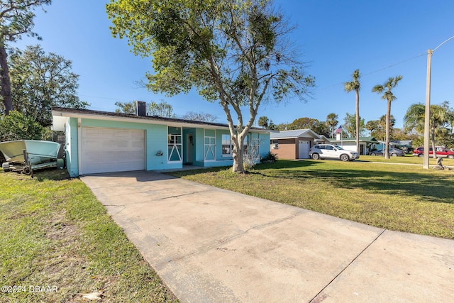 single story home featuring a front lawn and a garage