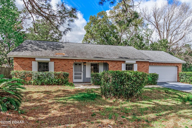 ranch-style home with a garage, a shingled roof, concrete driveway, and brick siding