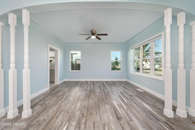 unfurnished room with a ceiling fan, baseboards, and wood finished floors