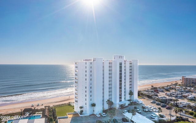 drone / aerial view featuring a water view and a beach view