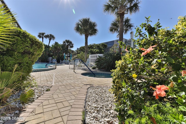 exterior space featuring a pool and a patio