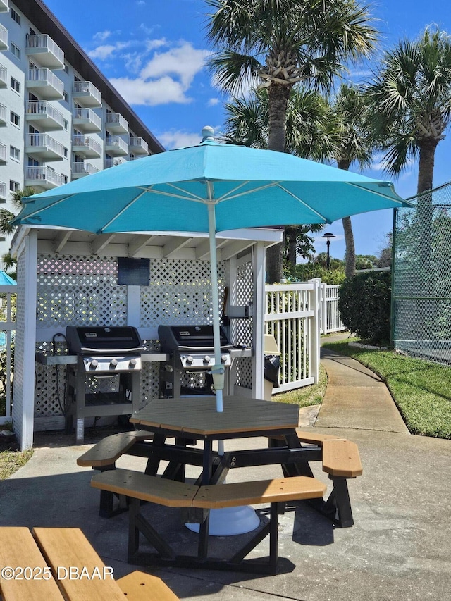 view of patio / terrace featuring outdoor dining area, grilling area, and fence