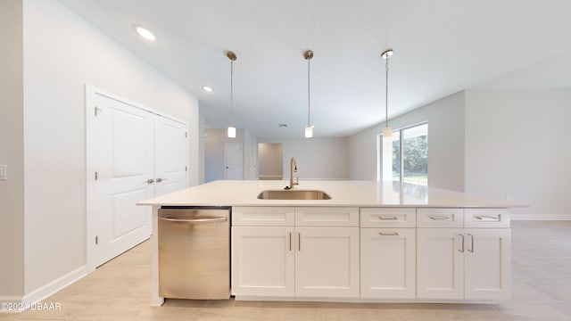 kitchen with a kitchen island with sink, white cabinets, hanging light fixtures, sink, and stainless steel dishwasher