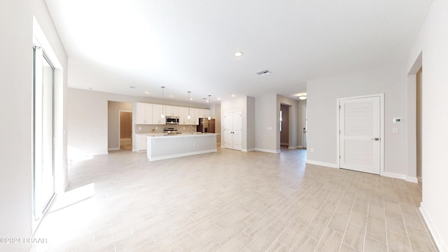 unfurnished living room with light hardwood / wood-style floors