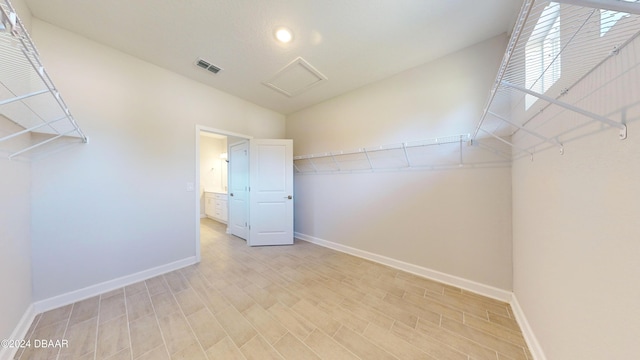 spacious closet with light hardwood / wood-style flooring