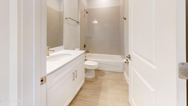 full bathroom featuring vanity, toilet, and tiled shower / bath combo