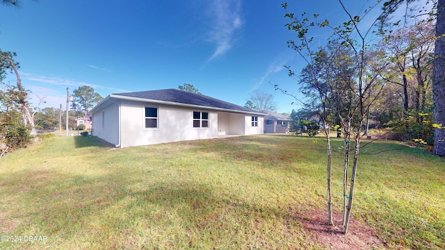 rear view of property with a yard