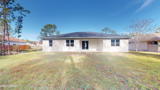 rear view of house with a yard