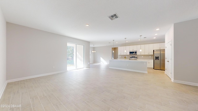 unfurnished living room with light hardwood / wood-style flooring