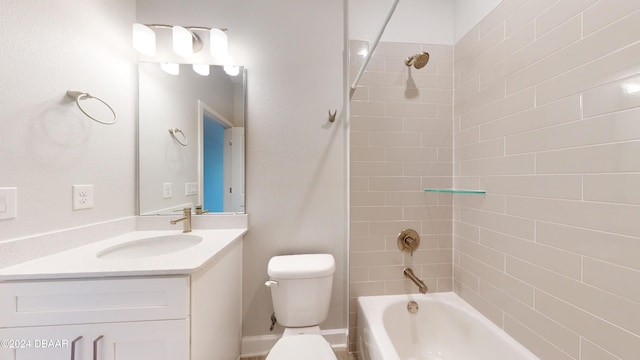 full bathroom with vanity, toilet, and tiled shower / bath