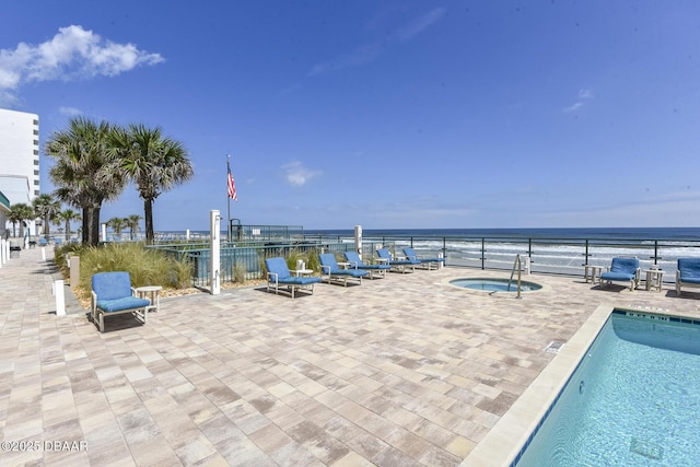 3315 S Atlantic Ave Unit 1606, Daytona Beach Shores, FL 32118 - community pool featuring a water view, a community hot tub, and a patio area