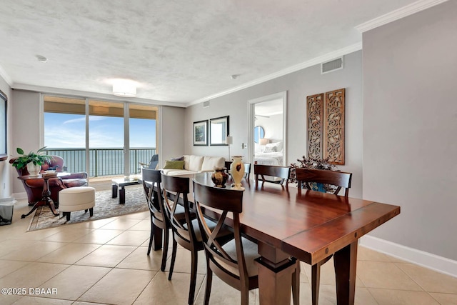 3315 S Atlantic Ave Unit 1606, Daytona Beach Shores, FL 32118 - dining area with light tile patterned floors and crown molding