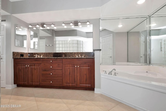3315 S Atlantic Ave Unit 1606, Daytona Beach Shores, FL 32118 - bathroom featuring tile patterned floors, double vanity, and a garden tub