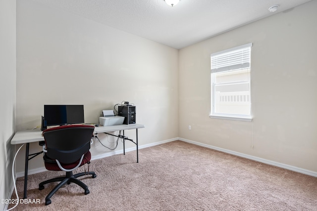 home office featuring a textured ceiling, carpet flooring, and baseboards