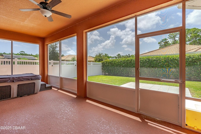 unfurnished sunroom featuring ceiling fan