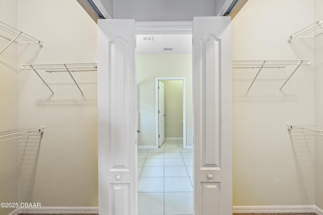 walk in closet featuring visible vents and light tile patterned floors