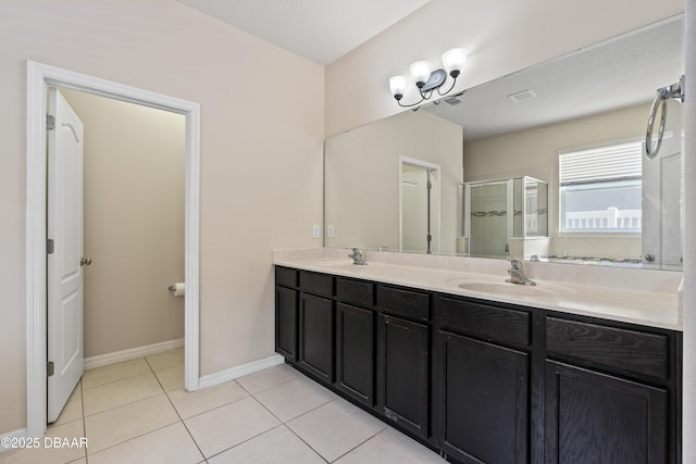 bathroom featuring tile patterned flooring, a sink, a shower stall, and double vanity