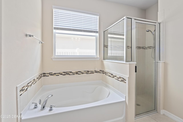 bathroom featuring tile patterned flooring, a shower stall, and a bath