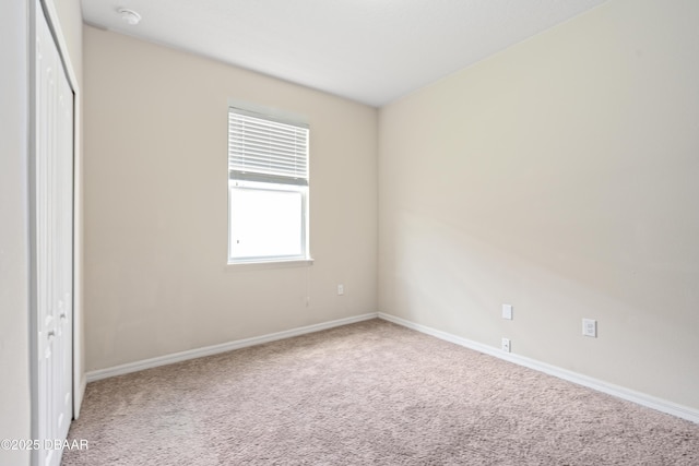 unfurnished bedroom with a closet, carpet flooring, and baseboards