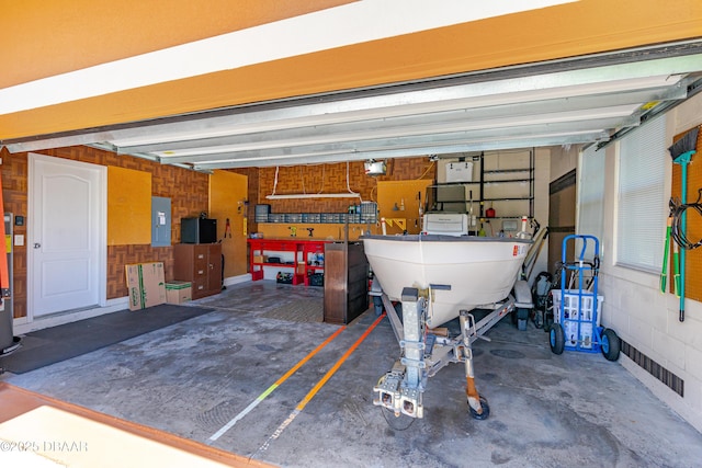 garage with electric panel and a garage door opener