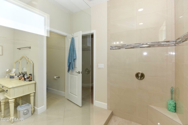 bathroom featuring tile patterned flooring and tiled shower