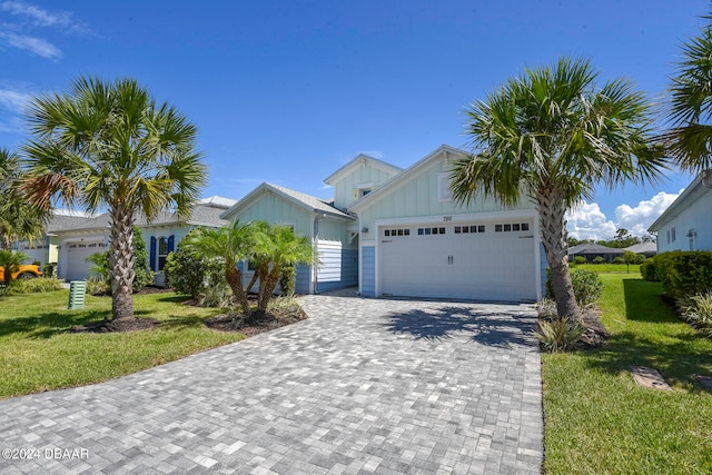 view of front of home with a garage and a front lawn