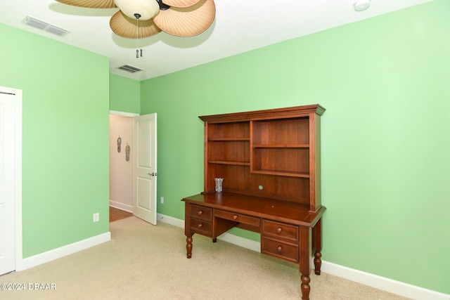 carpeted office space featuring ceiling fan