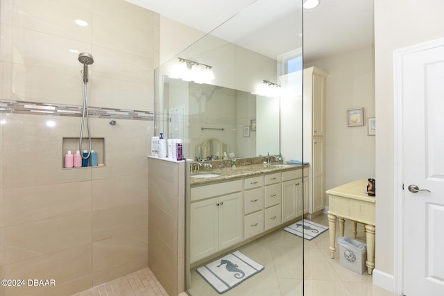 bathroom featuring vanity, tile patterned floors, and tiled shower