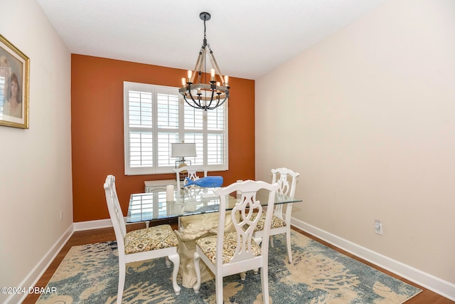 dining room with an inviting chandelier and wood-type flooring