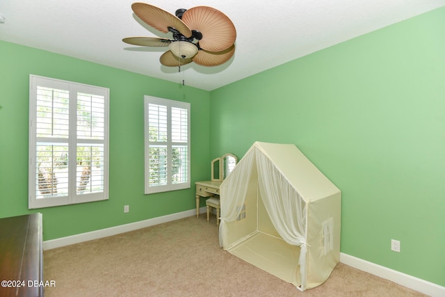 bedroom featuring ceiling fan and light carpet