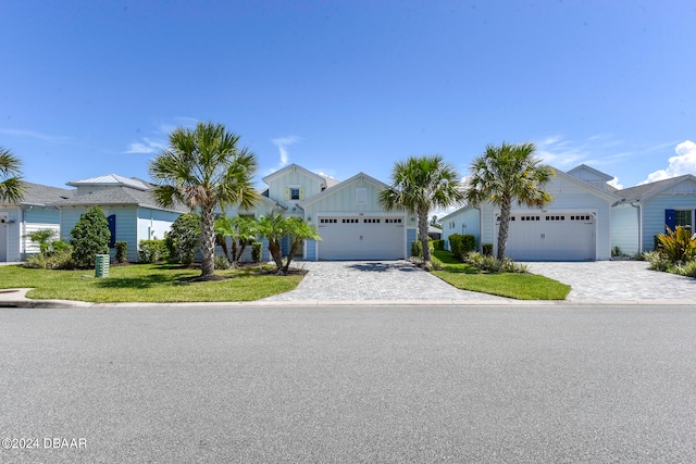 view of front of property featuring a garage and a front lawn