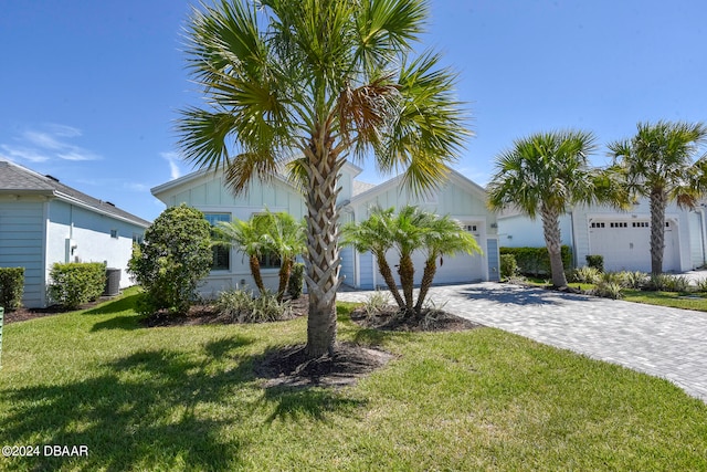 view of front of house with a front lawn and a garage