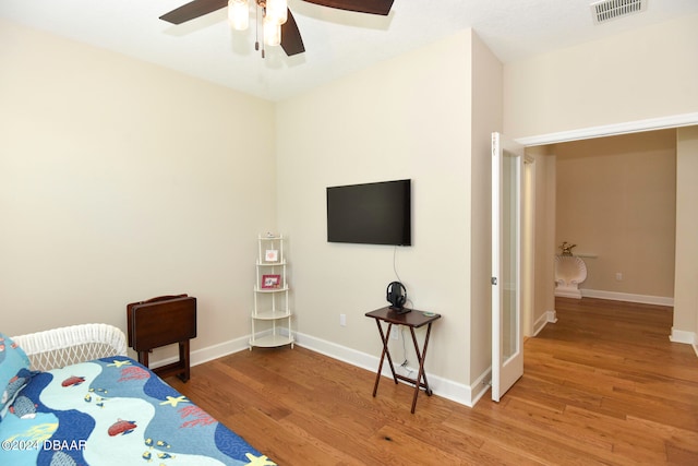 bedroom with hardwood / wood-style floors and ceiling fan